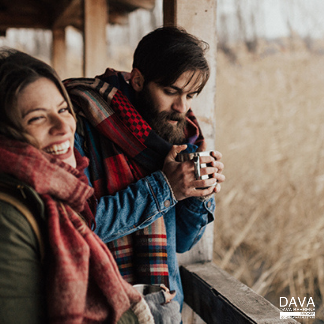 Couple enjoying warm drinks outdoors.