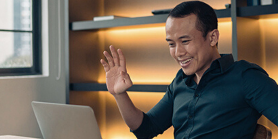 Man video conferencing at his desk.