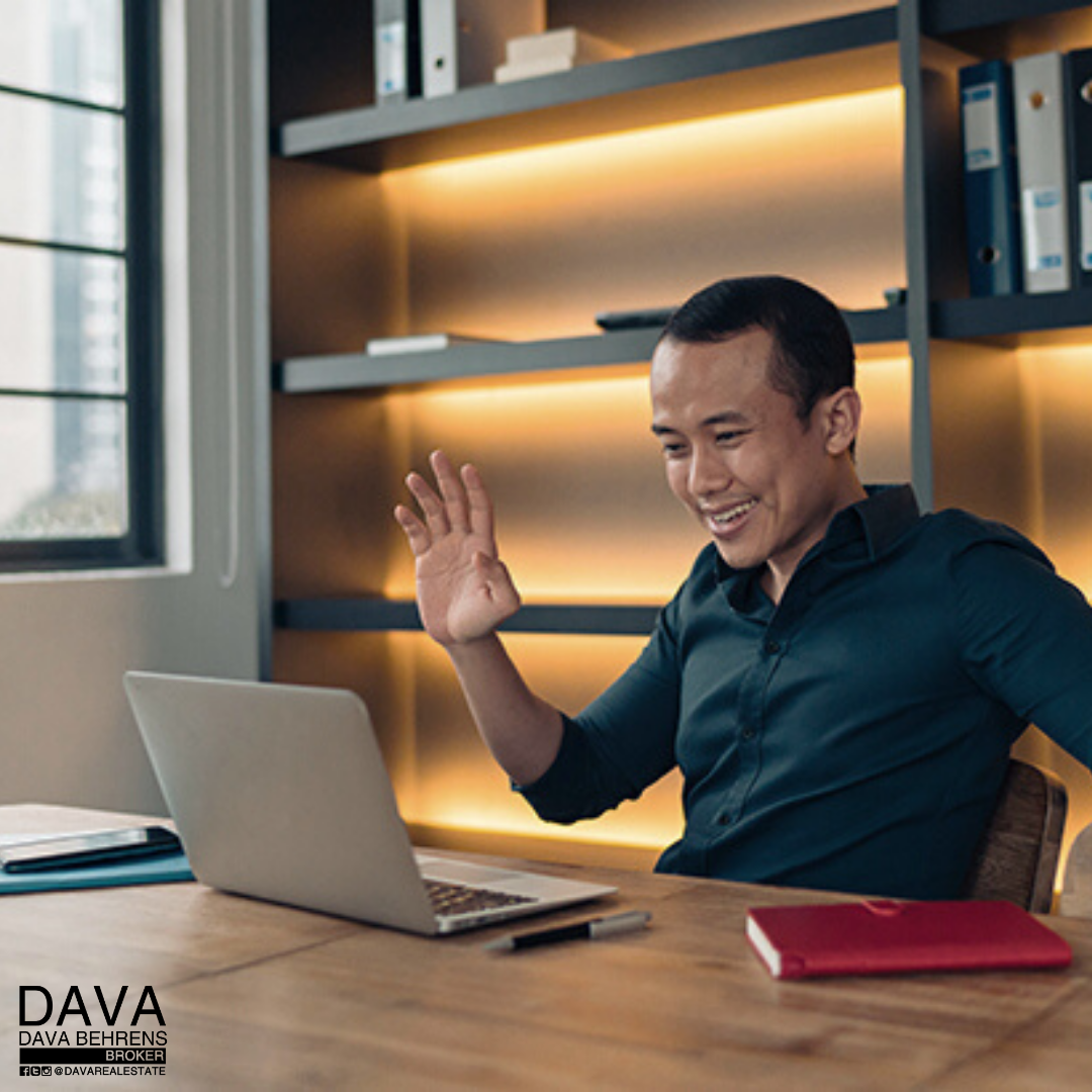 Man video conferencing at his desk.