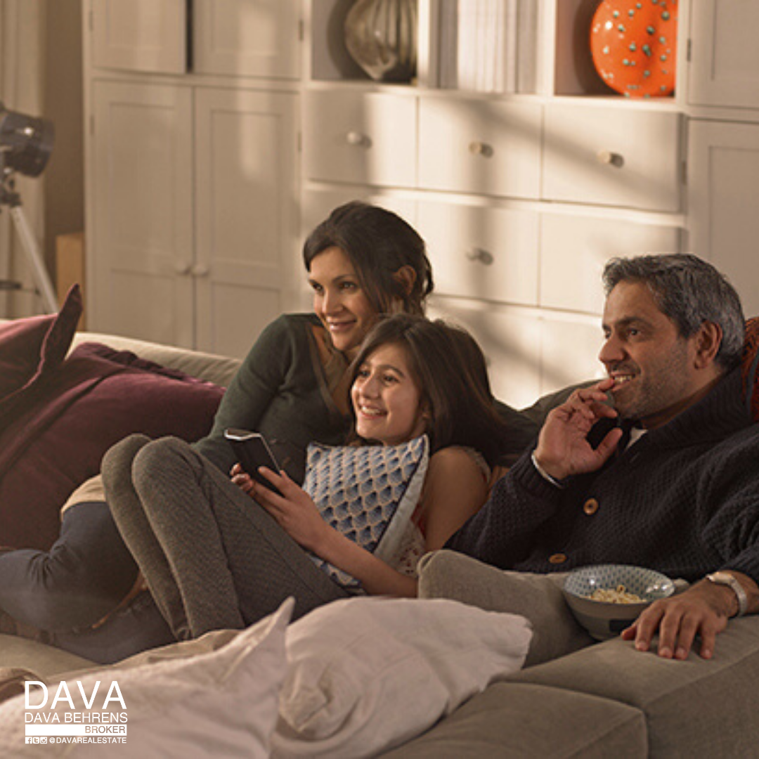 Family relaxing at home watching TV.