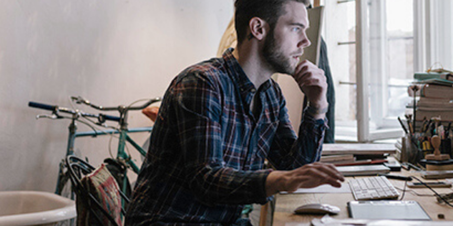 Man working on computer at home.