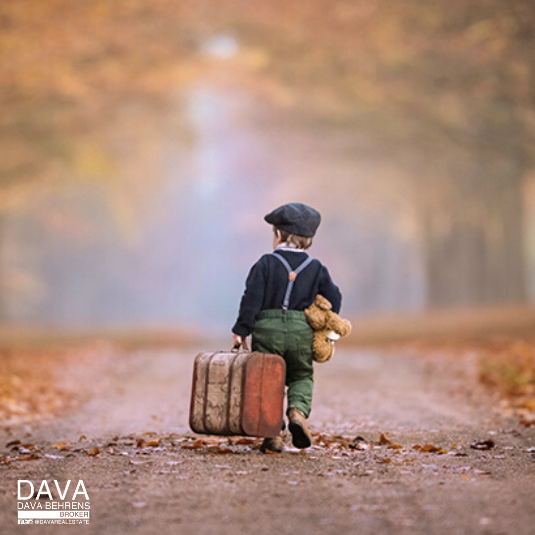 Child walks away with suitcase and teddy.