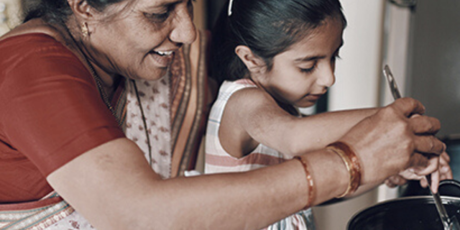 Grandmother and granddaughter cooking together.