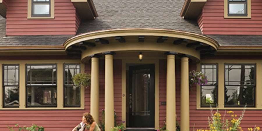 Woman and dog on craftsman porch.