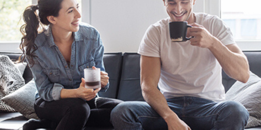 Couple relaxing at home with coffee.