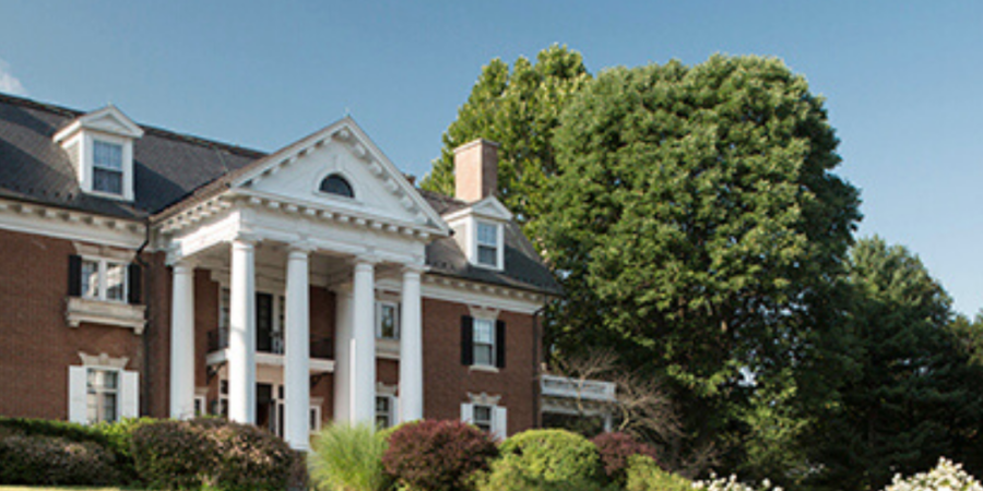 Grand brick mansion on a hill.