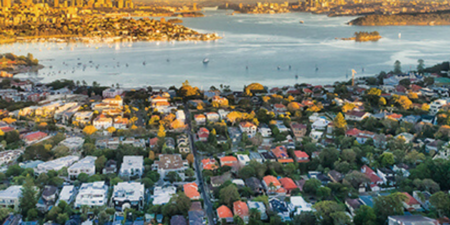 Aerial view of Sydney suburbs at sunset.