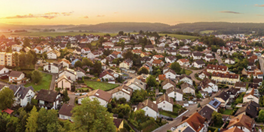 Aerial view of suburban neighborhood at sunset.