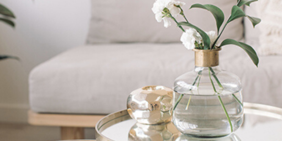 White flowers in glass vase on table.