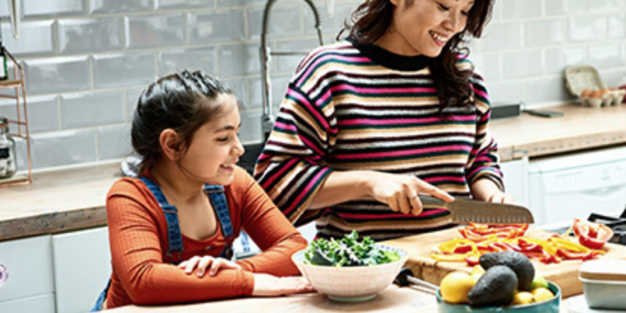 Mom and daughter preparing healthy meal.