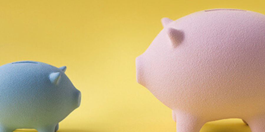 Large and small piggy banks saving money.