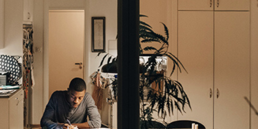 Man working late at home desk.