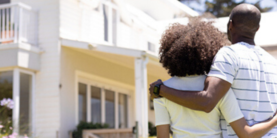 Couple admiring new house exterior.