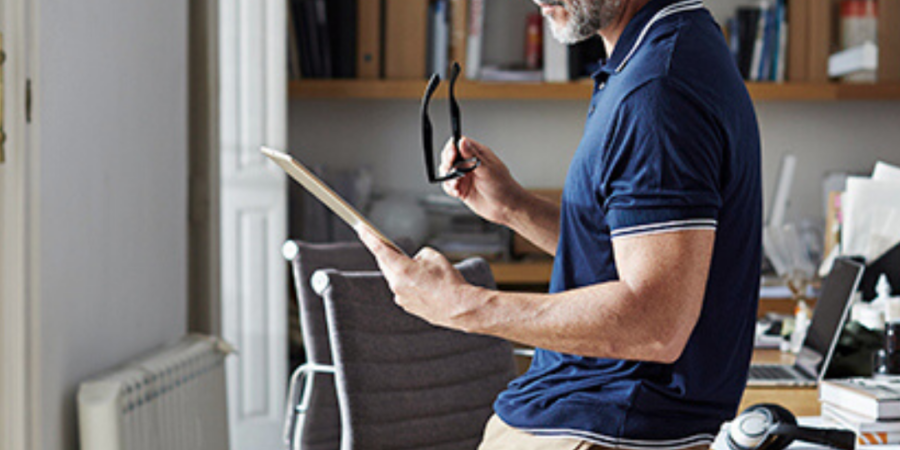 Man reviewing documents on tablet.