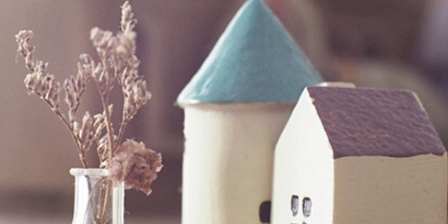 Miniature houses and dried flowers.