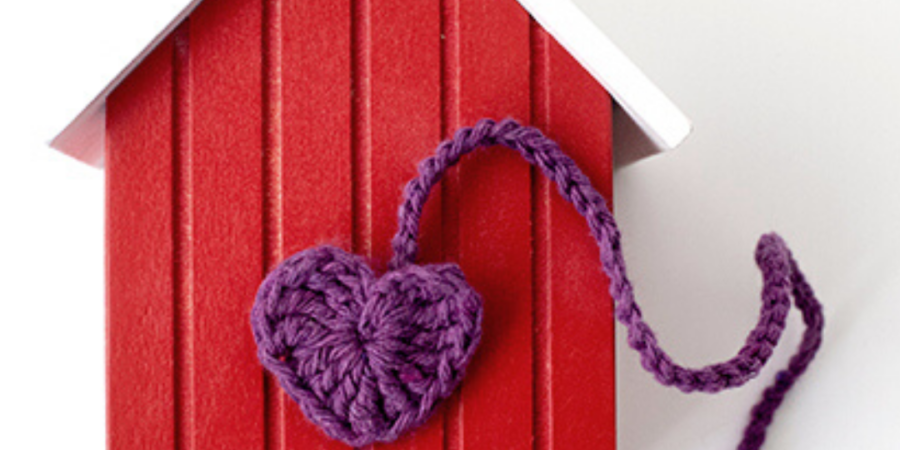 Purple heart on red house model.