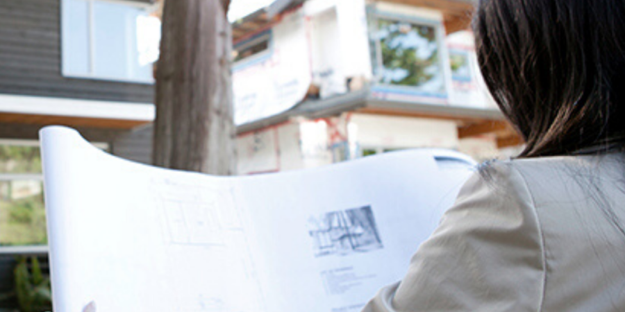 Woman reviewing house blueprints.