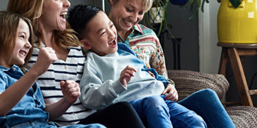 Happy family relaxing on sofa together.