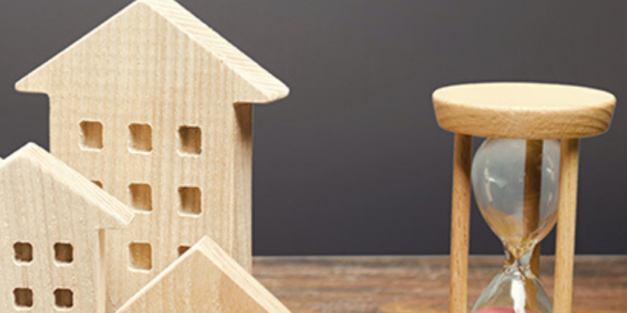 Wooden house models and hourglass.