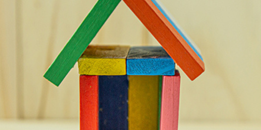 Colorful blocks forming a toy house.