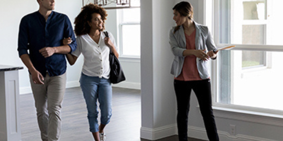 Couple touring new house with realtor.