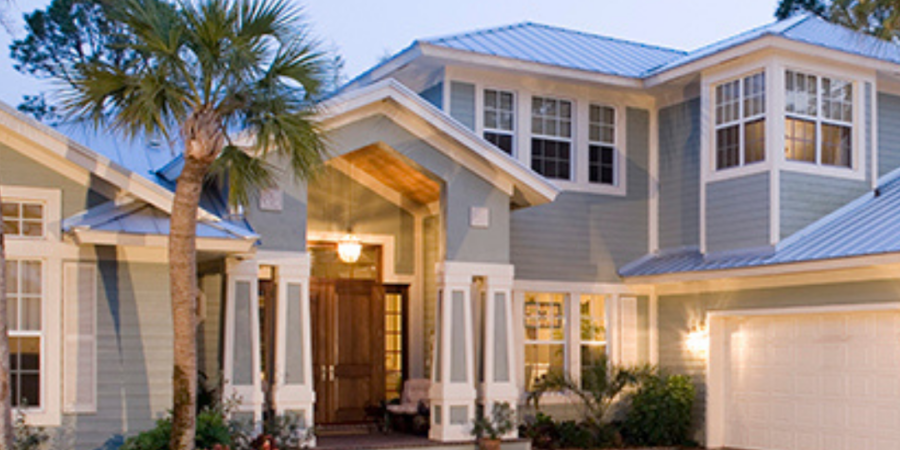 Luxury waterfront home at dusk.