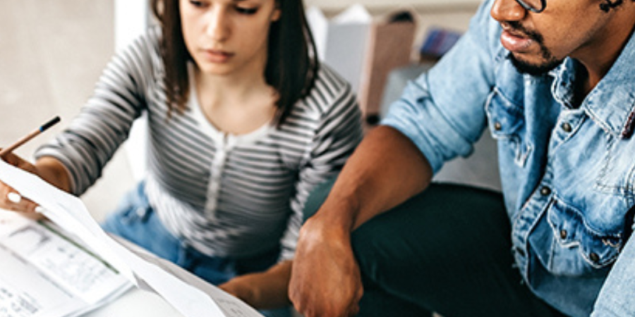 Couple reviewing paperwork together.