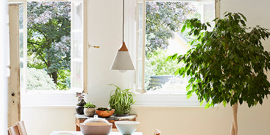 Bright dining room with light fixture.