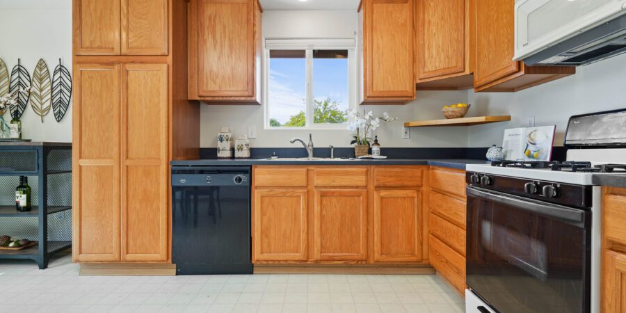 Oak kitchen with black appliances.
