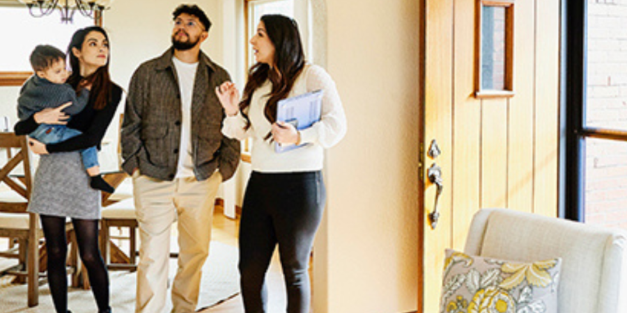 Family viewing home with real estate agent.