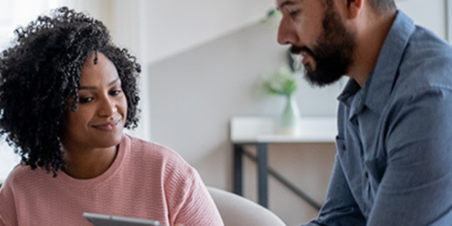 Couple reviewing documents with realtor.