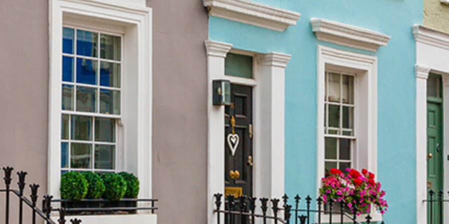 Colorful houses with black railings.