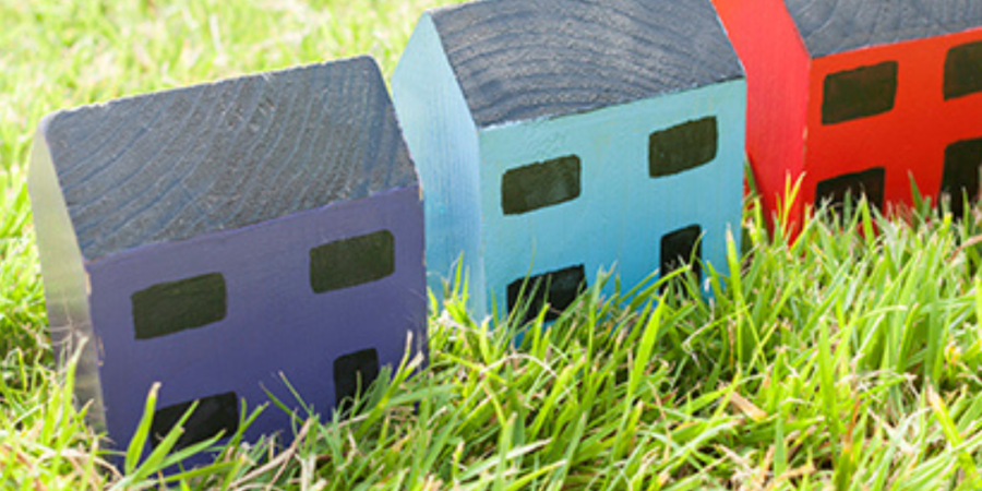 Colorful wooden houses in grass.