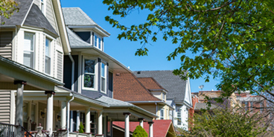 Row of charming houses, tree-lined street.