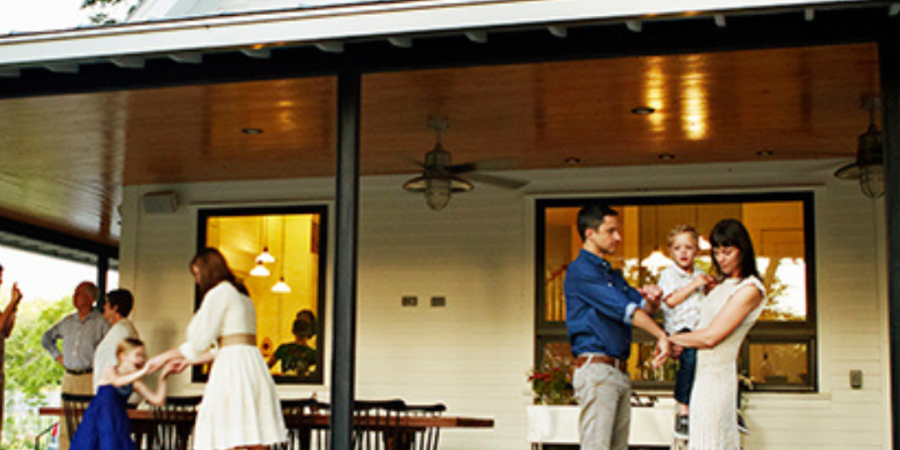 Family gathering on a spacious porch.