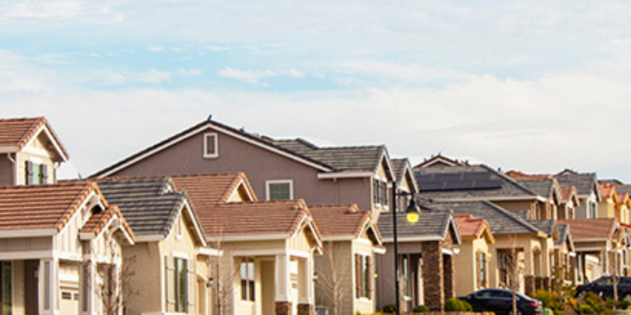 Row of houses on a sunny street.