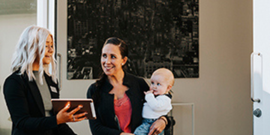 Real estate agent showing property to family.