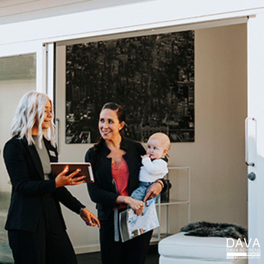 Real estate agent showing property to family.