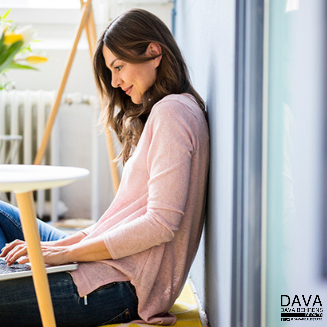 Woman working on laptop indoors.