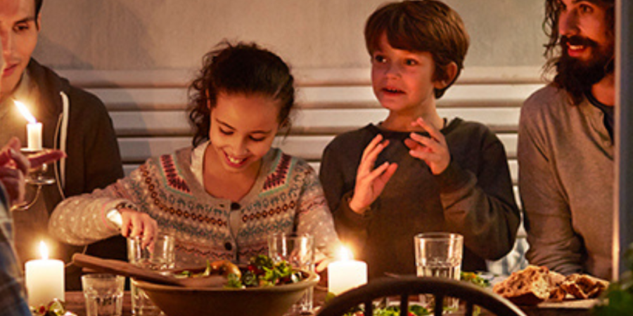 Family enjoying a candlelit dinner.