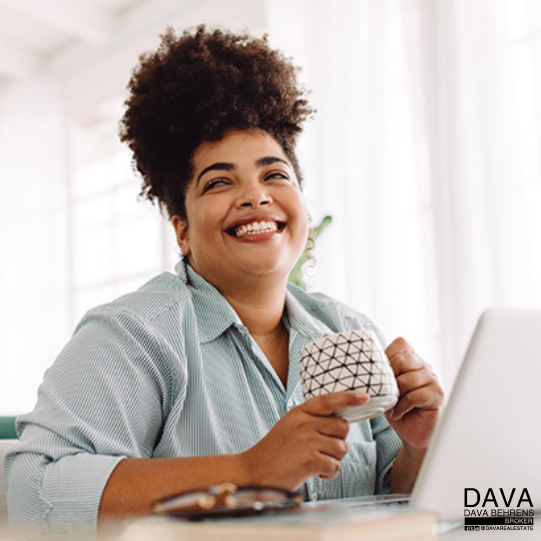 Happy woman enjoying coffee at work.