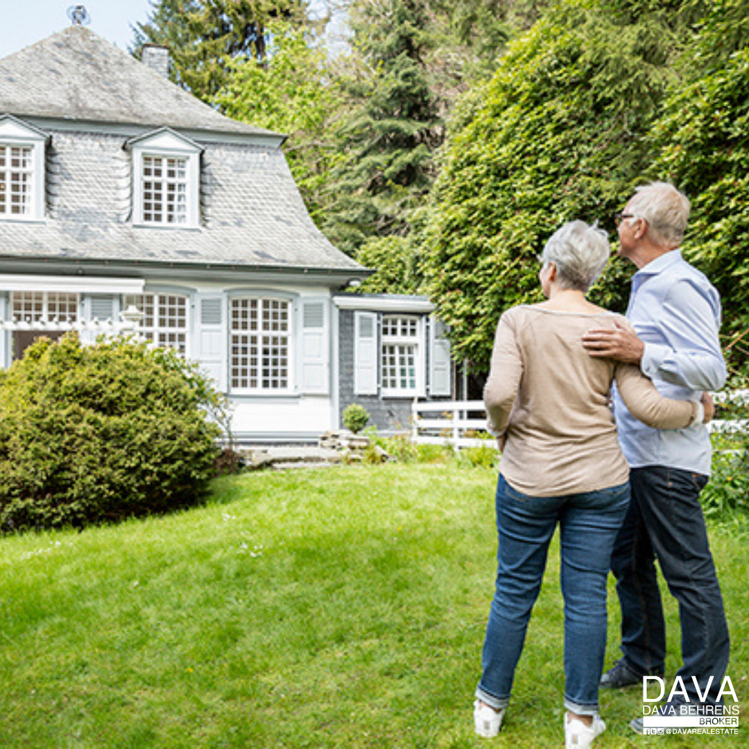 Senior couple admiring new house.