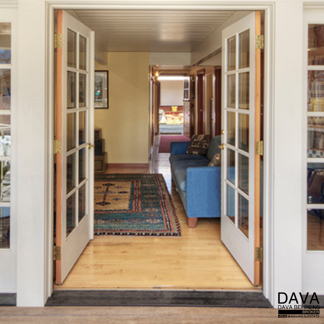 French doors open to hallway and living room.