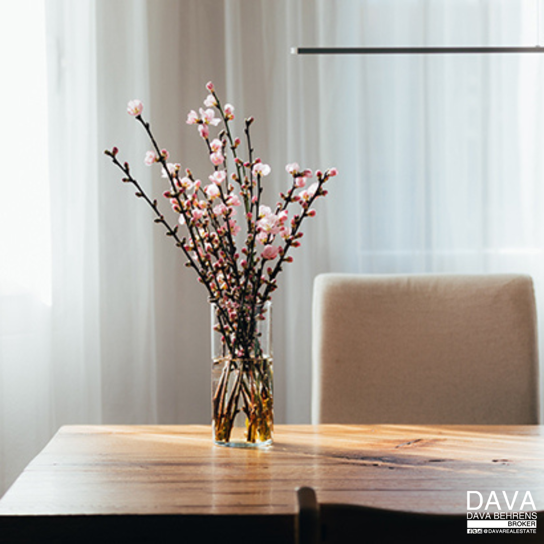 Pink flowers in glass vase on table.