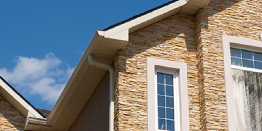 Stone house with new gutters and downspout.