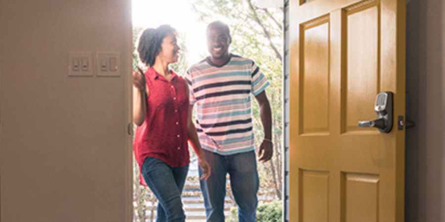 Happy couple entering new home.