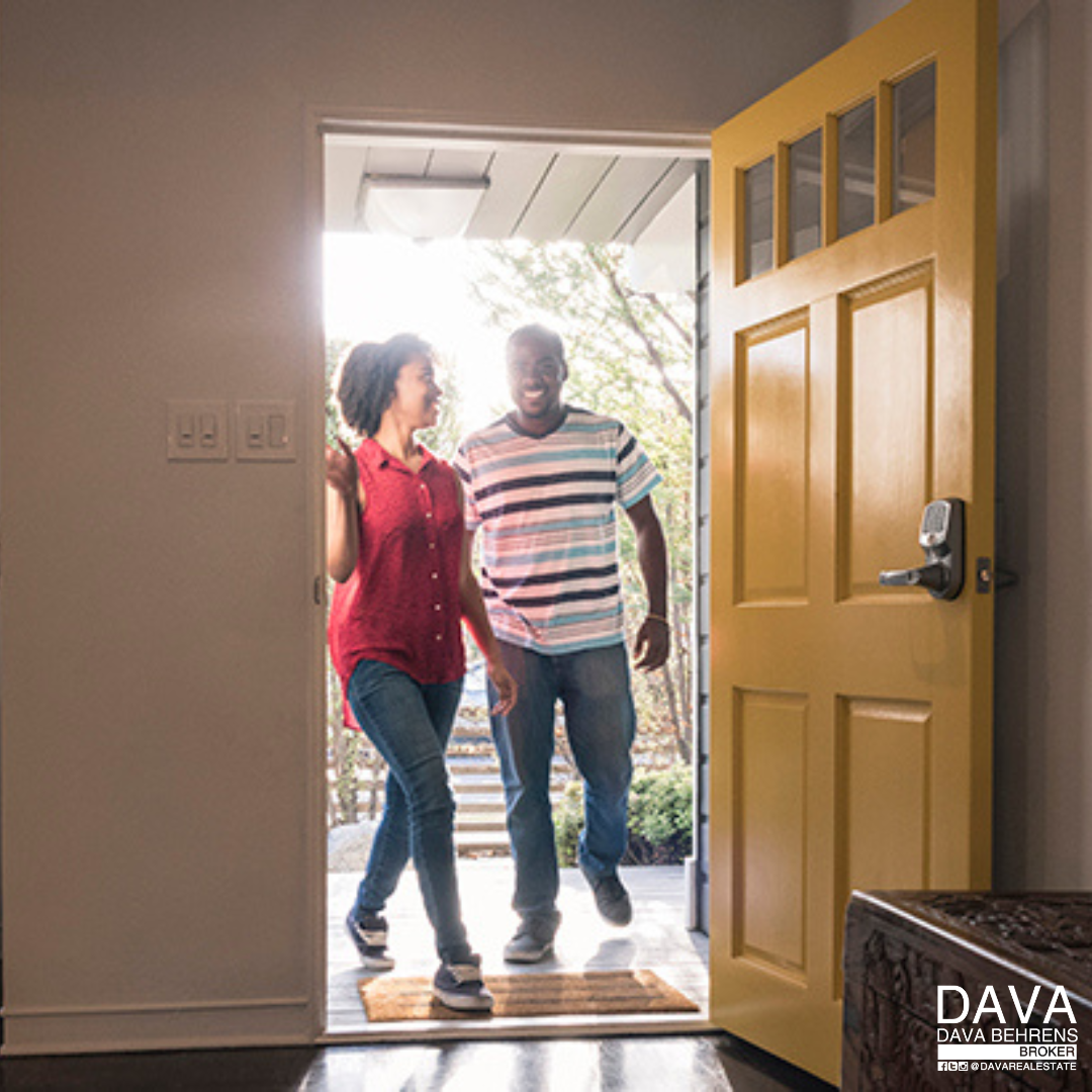 Happy couple entering new home.