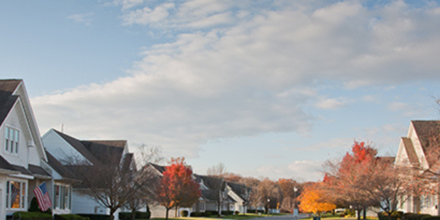 Suburban street lined with autumn homes.