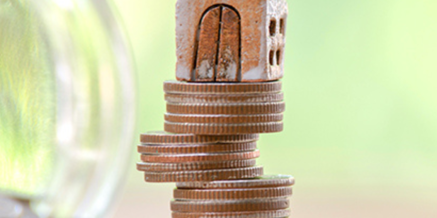 House model on a stack of coins.