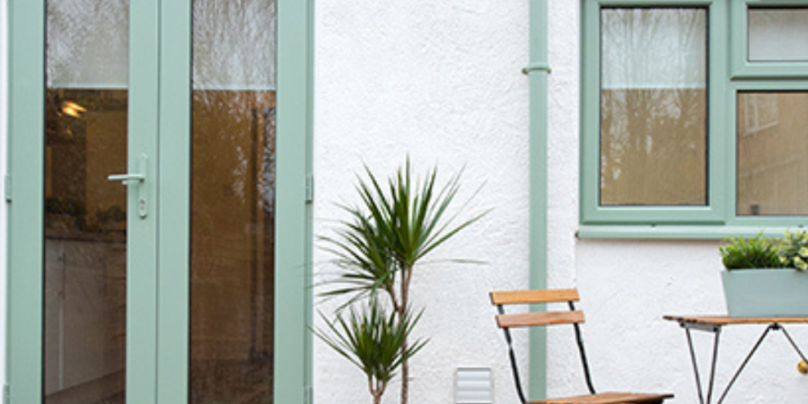 Pastel green French doors and patio.